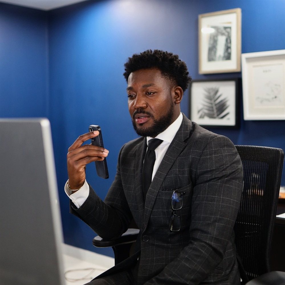 Abdias Alexander, Founder & CEO of Centric Realty Services, at his desk